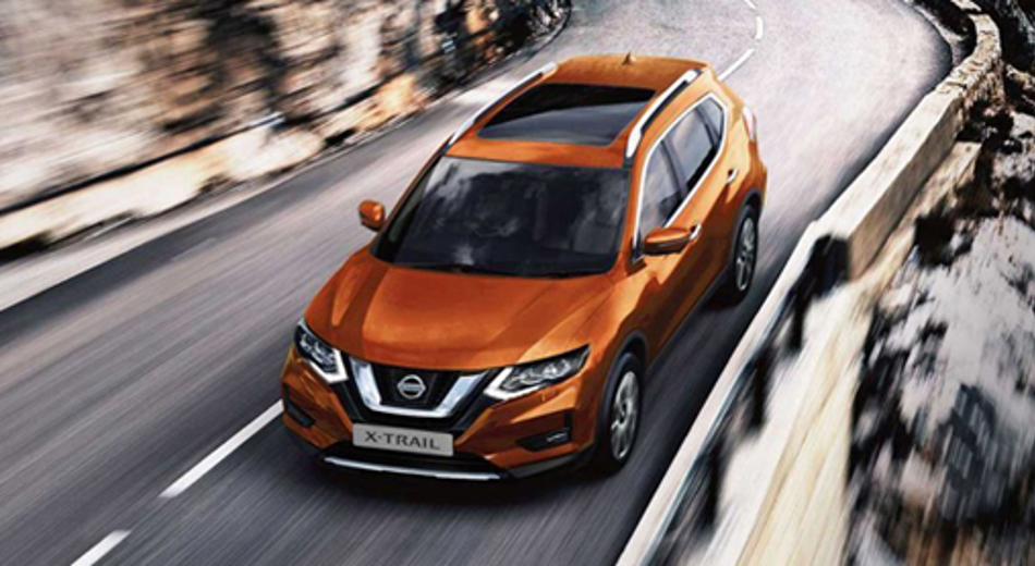 Orange X-Trail driving on road